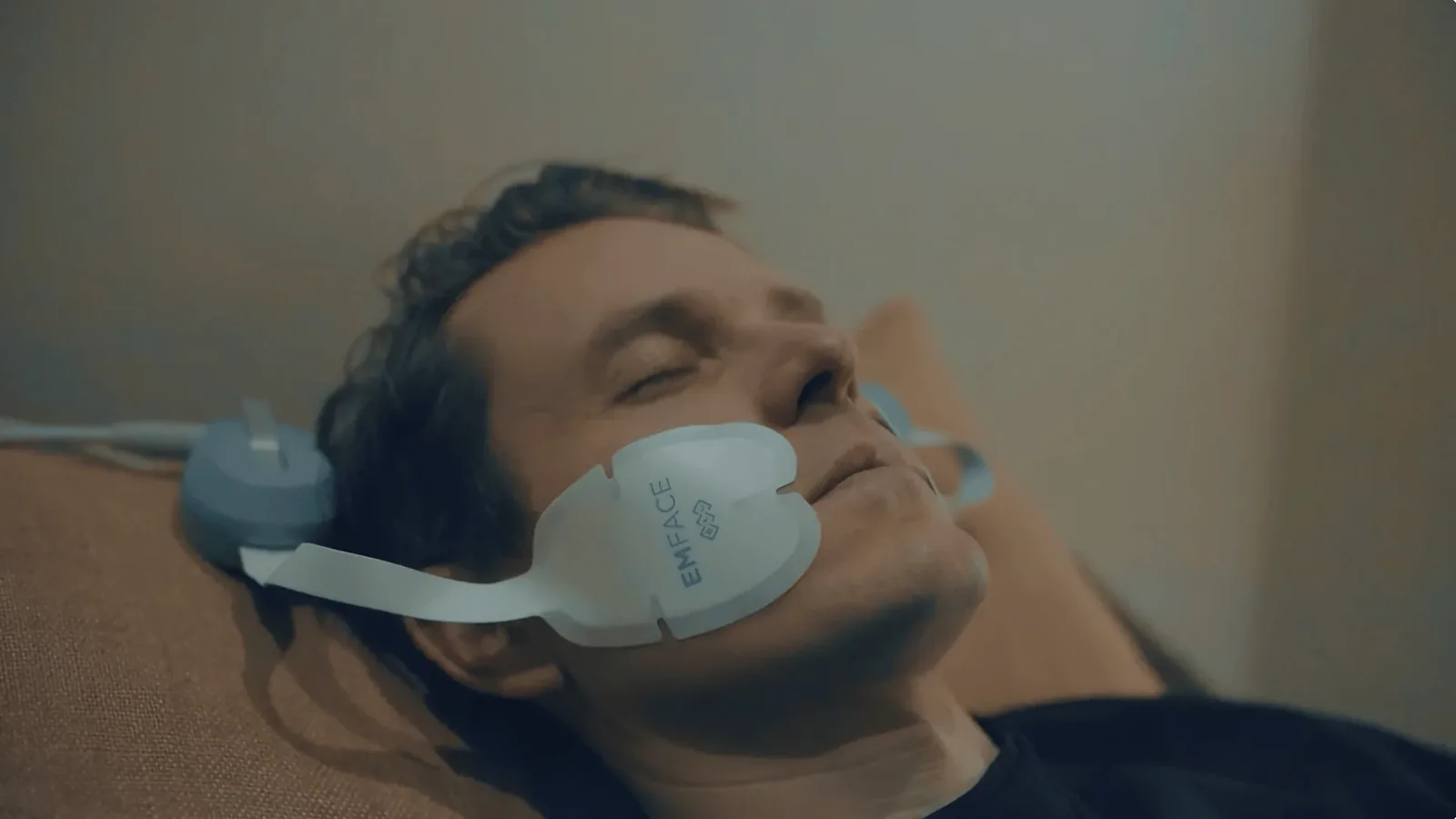 Emface treatment applicators placed on the forehead and cheeks