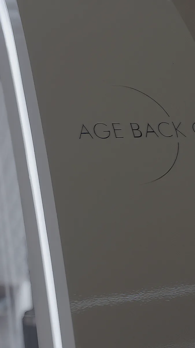 Age Back logo etched into the glass entrance door of the Stockholm clinic